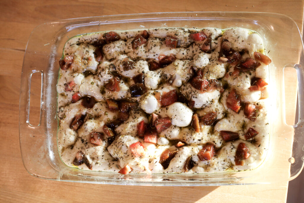 bread dough in a glass pan 